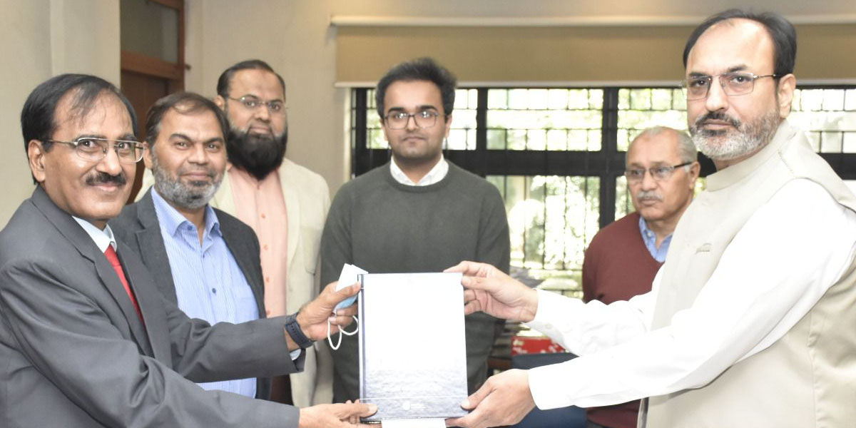 Dr. Muhammad Akram Tahir is seen presenting a book as a gift to UET Lahore while Vice Chancellor Prof. Dr. Shahid Munir (TI) receives the book with appreciation.